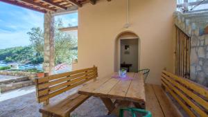 a wooden table with a vase on it on a patio at Apartment Slatina Bay in Vela Luka +35 photos