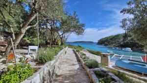 a house with a view of the water and a boat at Apartment Slatina Bay in Vela Luka