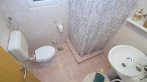 a small bathroom with a toilet and a sink at Apartment Slatina Bay in Vela Luka