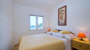 a bedroom with a bed and a window at Apartment Slatina Bay in Vela Luka