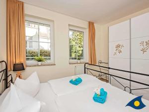 Postel nebo postele na pokoji v ubytování Dünen-Residenz C 08