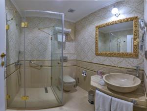 a bathroom with a toilet, sink and bathtub at The Galataport Hotel in Istanbul
