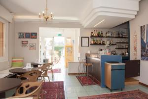 a restaurant with tables and chairs and a counter at Ute Hotel in Lido di Jesolo