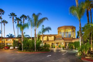 a building with palm trees in front of it at Handlery Hotel San Diego in San Diego