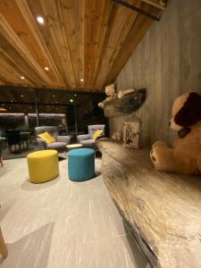 a living room with a teddy bear sitting on a couch at Les Mazots des Fées in Morzine