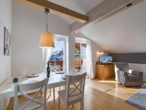 a kitchen and living room with a table and chairs at Ski-in, Ski-out by Apartment Managers in Kirchberg in Tirol