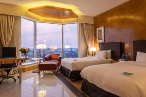 A bed or beds in a room at Lagos Continental Hotel