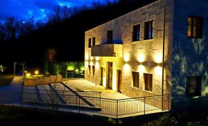 a building with lights on the side of it at night at Sotto Il Cielo Hotel in Pignola