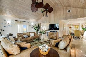 a large living room with couches and a tv at Villa of the Setting Sun in Pirates Cove