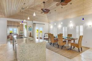 a kitchen and living room with a table and chairs at Villa of the Setting Sun in Pirates Cove