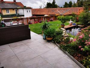 a garden with a patio and a pond with plants at ​Gästehaus Frans-Jozef in Mönichkirchen