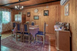 a dining room with a table and a refrigerator at Kuća za odmor Rukova Hiža, sauna, jacuzzi in Donja Stubica