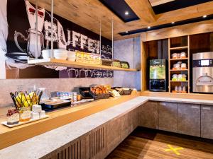 a kitchen with a counter with food on it at ibis budget Bordeaux Centre Mériadeck in Bordeaux