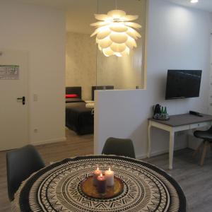 a living room with a table with candles on it at Minsu Hotel in Mülheim an der Ruhr