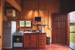 a kitchen with a stove and a refrigerator at Centro Los Alamos in Maldonado