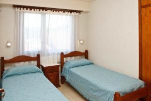 Un pat sau paturi într-o cameră la Complejo de Mar Wasiyki Villa Gesell