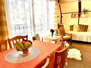 a room with a table with a bowl of fruit on it at Hotel a Penzion PEGAS in Nové Město na Moravě