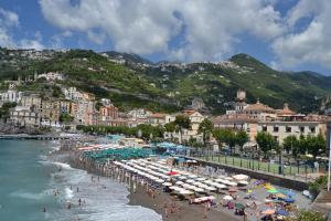 a beach with umbrellas and people on the beach at Casa Vacanze Nonno Aldo in Minori