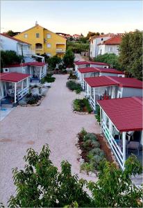 een rij huizen met rode daken in een stad bij Fjaka Camp in Pakoštane