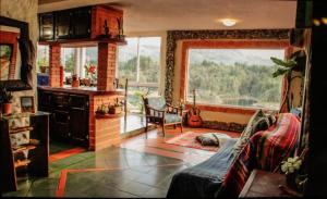 a living room with a couch and a fireplace at Casa Encuentro Ecolodge, Outdoor Gym and Yoga in Guatapé