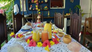 a table with a table cloth with drinks on it at Guest House Boki da Zezé in Marau