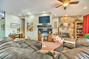 a living room with a couch and a fireplace at Homey Lakefront Hideaway with 2 Decks and Dock! in Fenton
