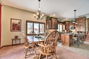 a kitchen with a dining room table and chairs at Homey Lakefront Hideaway with 2 Decks and Dock! in Fenton