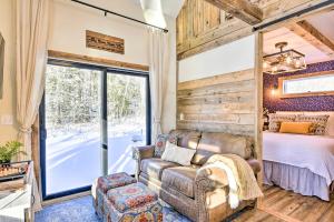 a bedroom with a couch and a bed and a window at Cozy Home with Yard about 6 Mi to Stowe Mountain! in Stowe
