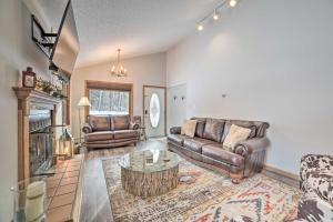 a living room with leather furniture and a fireplace at Harbor Springs Rental Home Swim and Boat Nearby! in Harbor Springs