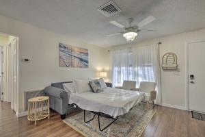 a living room with a bed and a couch at Calming Getaway 9 Mi to Clearwater Beach! in Clearwater