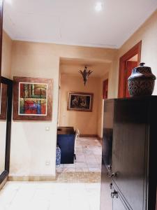 a living room with a large vase on top of a refrigerator at Palmeraie Village in Marrakesh