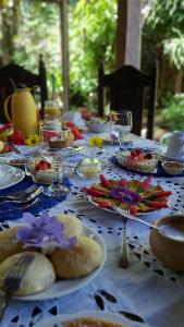 a long table with plates of food on it at Guest House Boki da Zezé in Marau +17 photos