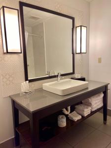 a bathroom with a sink and a large mirror at Country Inn & Suites by Radisson, Jackson, TN in Jackson