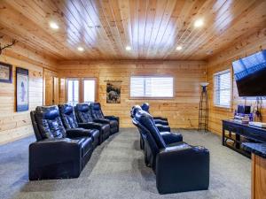 a room with leather chairs and a flat screen tv at Copper Top - Stunning Views, and Hot Tub in Sevierville