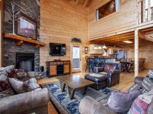 a living room with couches and a fireplace at Copper Top - Stunning Views, and Hot Tub in Sevierville