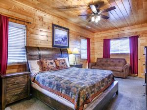 a bedroom with a bed and a chair in a cabin at Copper Top - Stunning Views, and Hot Tub in Sevierville +79 photos