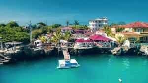 a small boat in the water at a resort at Hotel Angermeyer Waterfront Inn in Puerto Ayora