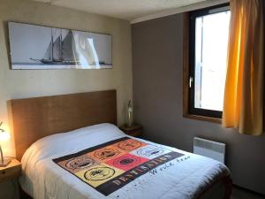 a bedroom with a bed with a poster on it at Appartement Station de ski - Les Agudes - 6 pers in Gouaux-de-Larboust