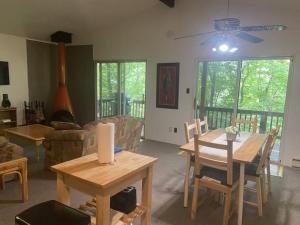 a living room with a wooden table and chairs at Clubhouse Lakeview Chalet in East Stroudsburg