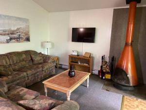 a living room with a couch and a coffee table at Clubhouse Lakeview Chalet in East Stroudsburg
