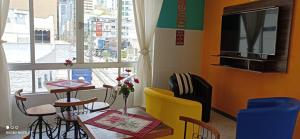 a dining room with a table and chairs and a window at SAXÔNiA HOTEL in Balneário Camboriú