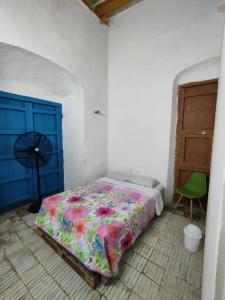 a bedroom with a bed and a blue door at VAMO A ROLA in Campeche