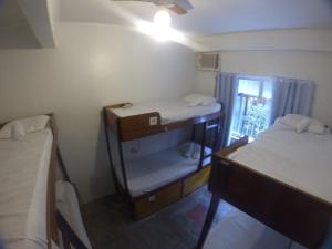 a small room with two bunk beds and a window at Copacabana Hostel in Rio de Janeiro