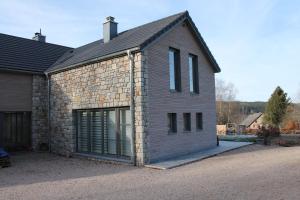 a large brick building with a large garage at La Veraison in Malmedy