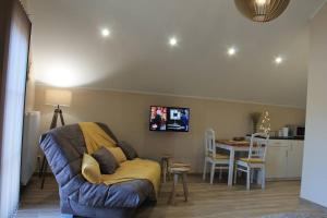 a living room with a couch and a table at La Veraison in Malmedy