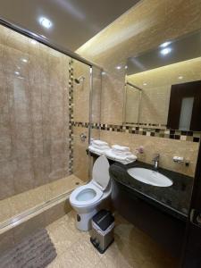 a bathroom with a toilet and a sink and a shower at PALMAR CENTER in El Guabo