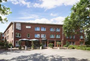 a large red brick building with a courtyard at GHOTEL hotel & living Kiel in Kiel