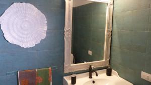a bathroom with a mirror and a sink at I Pesci nel golfo di Baratti in Baratti +22 photos