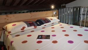 a bedroom with a large white bed with flowers on it at I Pesci nel golfo di Baratti in Baratti