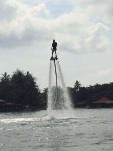 a man is standing on a boat in the water at Villa Alex in Beruwala